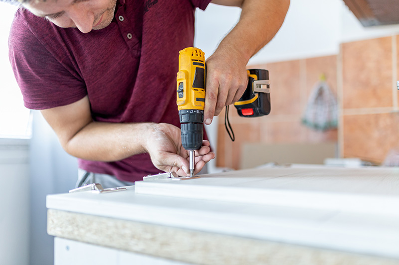 Man Using Cordless Drill