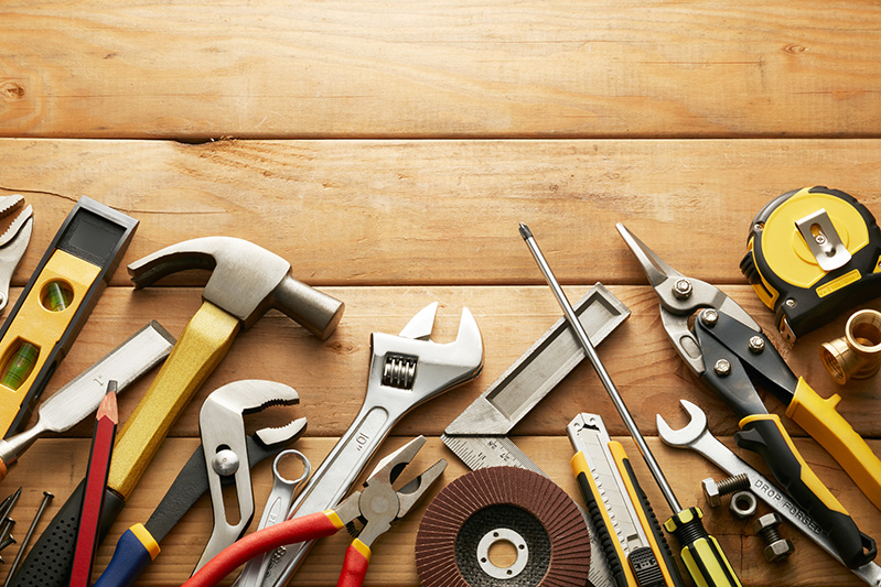 wood-tools-hardware-487125438 hand tools on a wood background